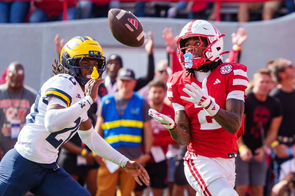 Sep 20, 2025; Lincoln, Nebraska, USA; Nebraska Cornhuskers wide receiver Jacory Barney Jr. (2) catches a pass for a touchdown against Michigan Wolverines defensive back Jyaire Hill (20) during the second quarter at Memorial Stadium. Mandatory Credit: Dylan Widger-Imagn Images