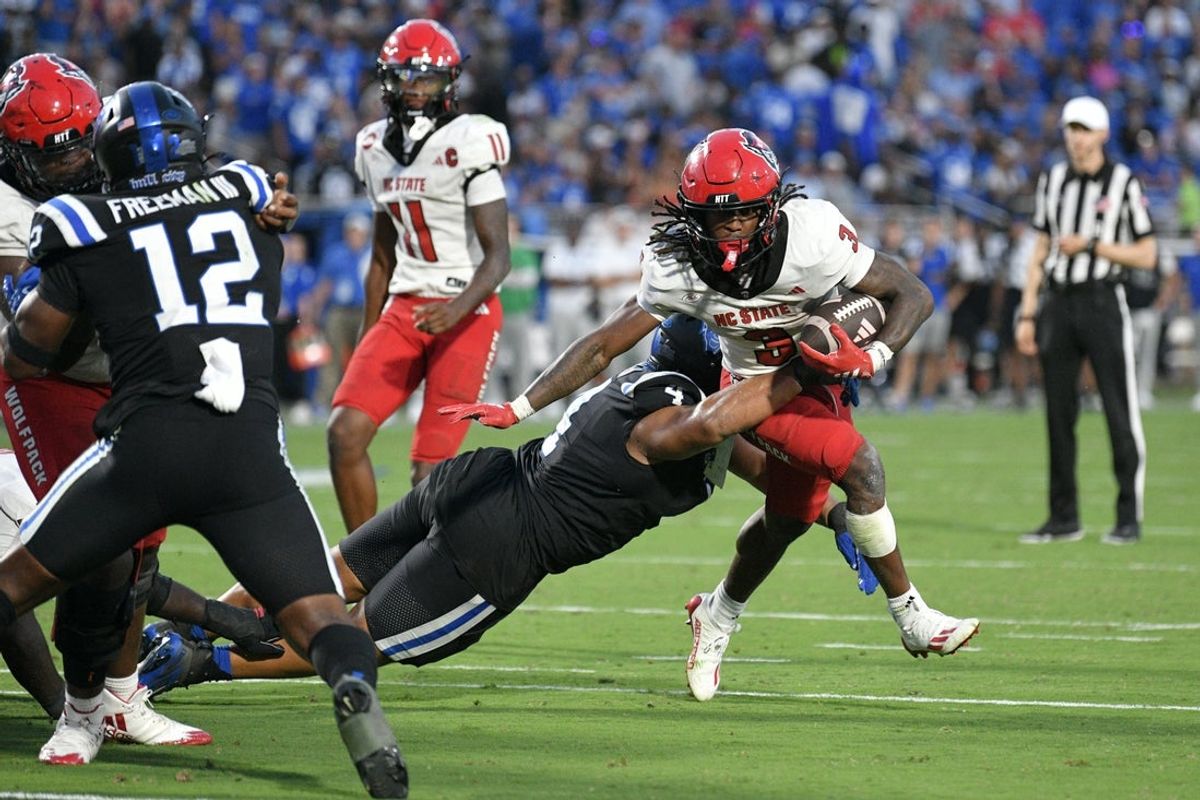 Sep 20, 2025; Durham, North Carolina, USA;  North Carolina State Wolfpack running back Hollywood Smothers (3) is tackled by Duke Blue Devils running back Anderson Castle (4) during the fourth quarter  at Wallace Wade Stadium. Mandatory Credit: Zachary Taft-Imagn Images