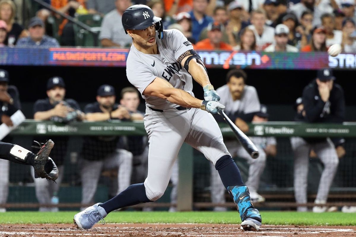 Sep 20, 2025; Baltimore, Maryland, USA; New York Yankees designated hitter Giancarlo Stanton (27) hits a home run during the first inning against the Baltimore Orioles at Oriole Park at Camden Yards. Mandatory Credit: Daniel Kucin Jr.-Imagn Images