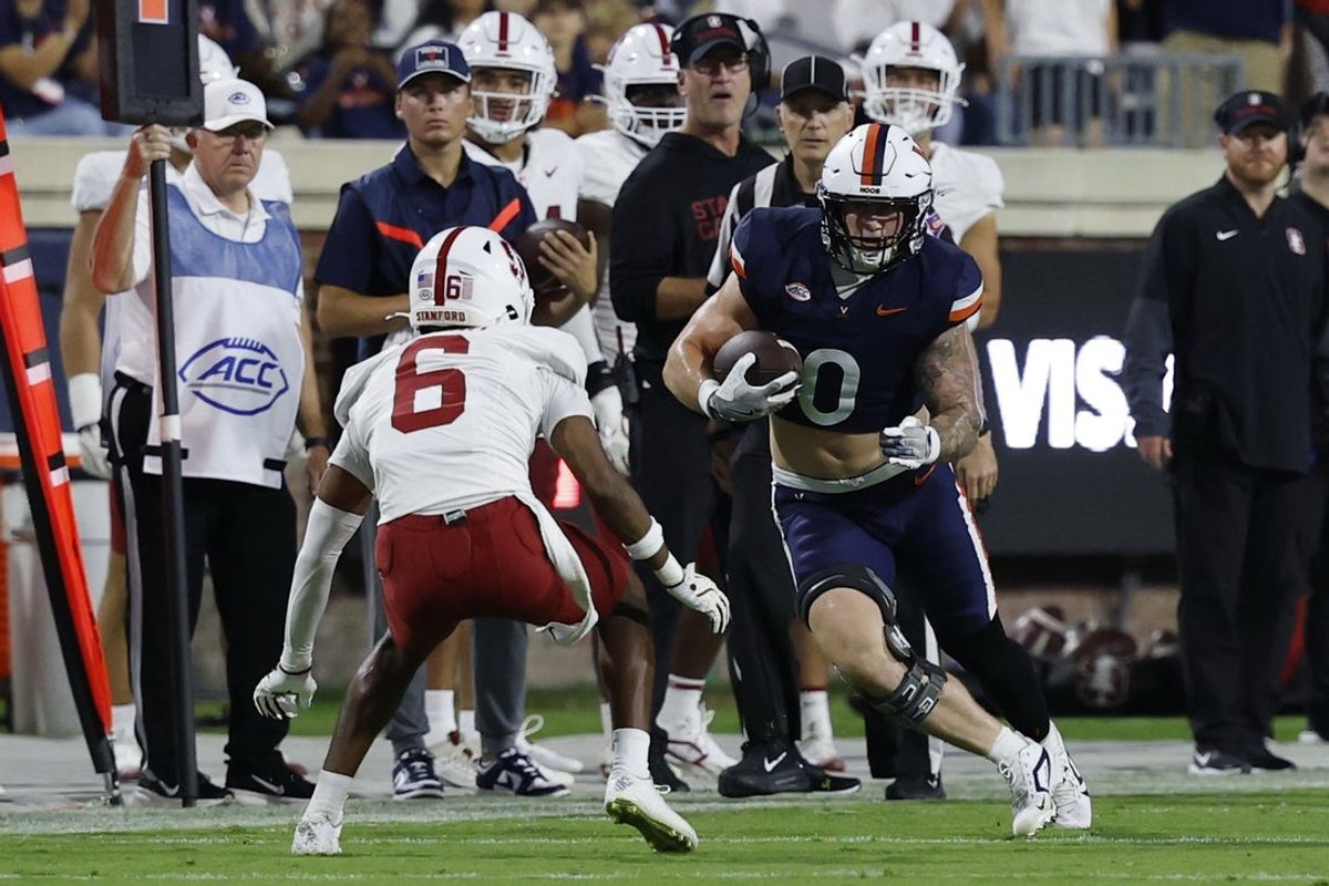 Sep 20, 2025; Charlottesville, Virginia, USA; Virginia Cavaliers tight end Sage Ennis (0) runs with the ball after making a catch as Stanford Cardinal cornerback Collin Wright (6) defends during the first quarter at Scott Stadium. Mandatory Credit: Geoff Burke-Imagn Images