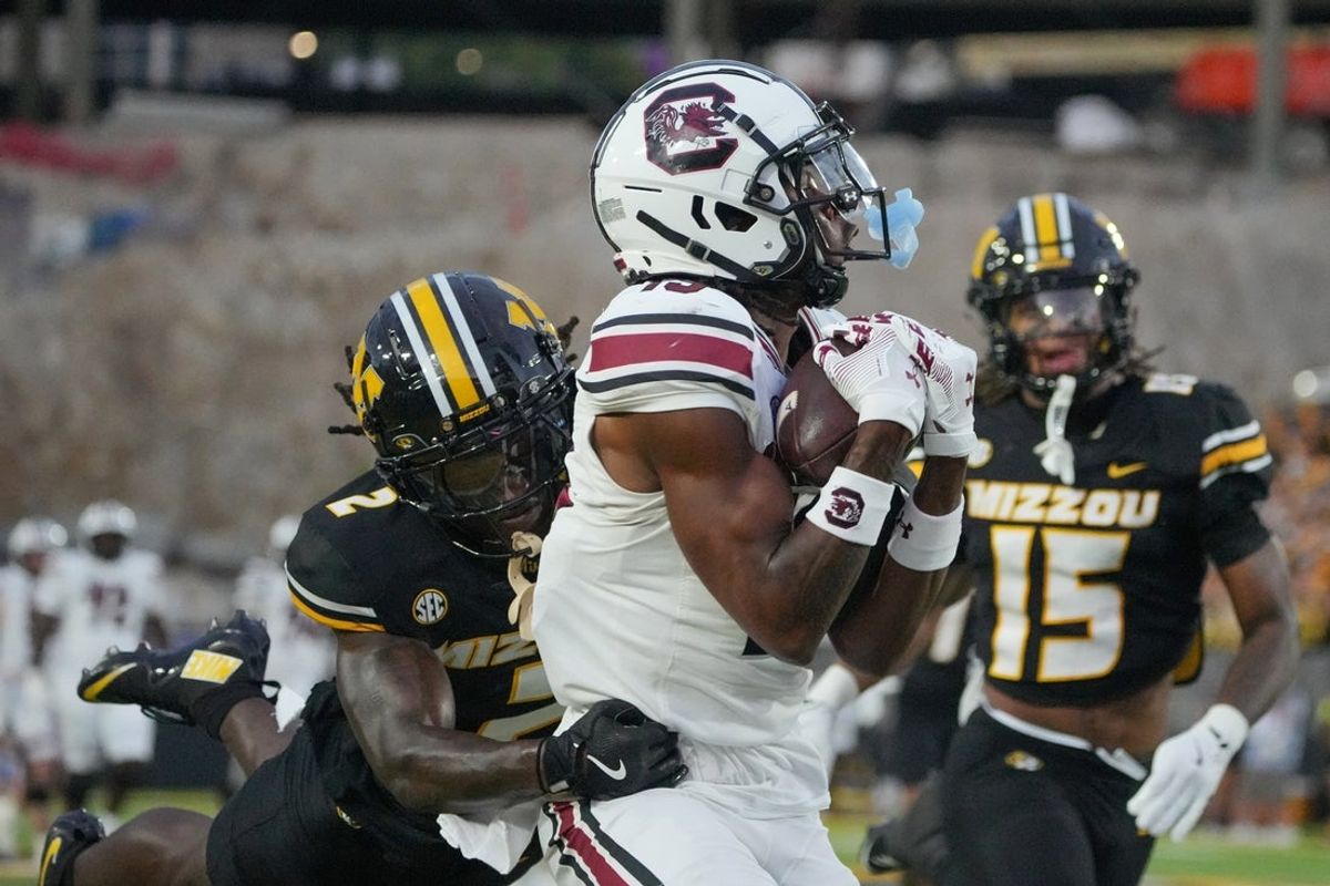 Sep 20, 2025; Columbia, Missouri, USA; South Carolina Gamecocks wide receiver Vandrevius Jacobs (19) catches a pass for a touchdown as Missouri Tigers cornerback Toriano Pride Jr. (2) attempts the tackle during the first half of the game at Faurot Field at Memorial Stadium. Mandatory Credit: Denny Medley-Imagn Images