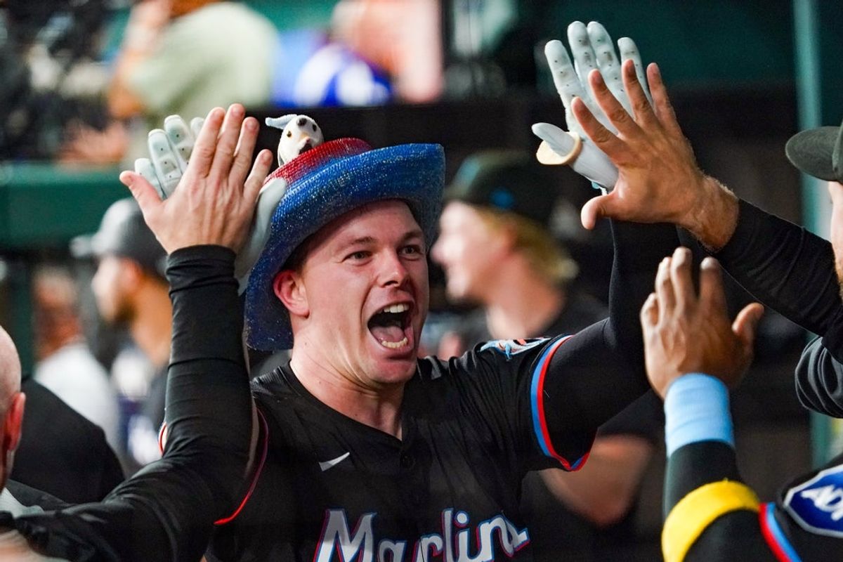 Sep 20, 2025; Arlington, Texas, USA; Miami Marlins outfield Troy Johnston (75) is greeted in the dugout after hitting a solo home run during the sixth inning against the Texas Rangers at Globe Life Field. Mandatory Credit: Raymond Carlin III-Imagn Images