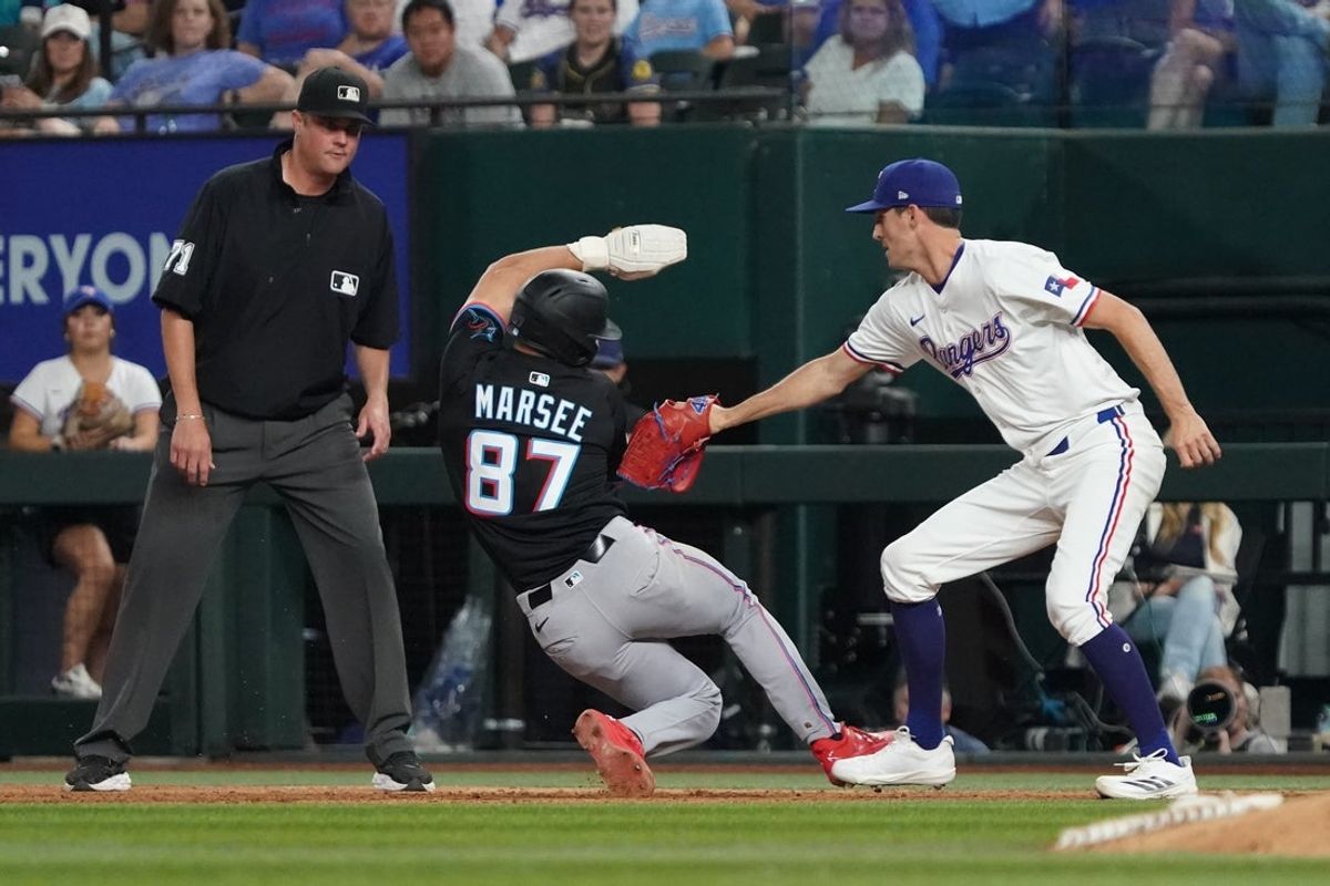 Sep 20, 2025; Arlington, Texas, USA; Miami Marlins outfielder Jakob Marsee (87) is tagged out by Texas Rangers pitcher Hoby Milner (41) after he was caught in a run-down during the ninth inning at Globe Life Field. Mandatory Credit: Raymond Carlin III-Imagn Images