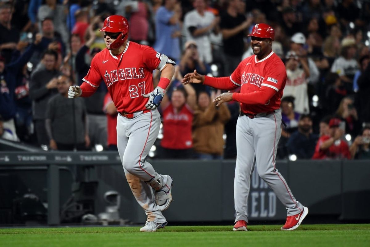 Sep 20, 2025; Denver, Colorado, USA; Los Angeles Angels designated hitter Mike Trout (27) is congratulated by third base coach Bo Porter (88) after hitting his 400th career home run during the eighth inning against the Colorado Rockies after at Coors Field. Mandatory Credit: Christopher Hanewinckel-Imagn Images