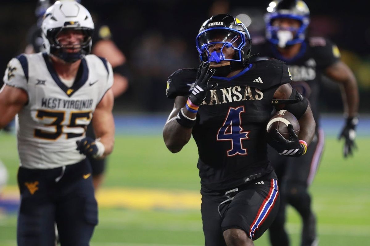 Kansas Jayhawks running back Leshon Williams (4) runs the ball in for a touchdown during the second half of the game against West Virginia Mountaineers at David Booth Kansas Memorial Stadium on Sept. 20, 2025.