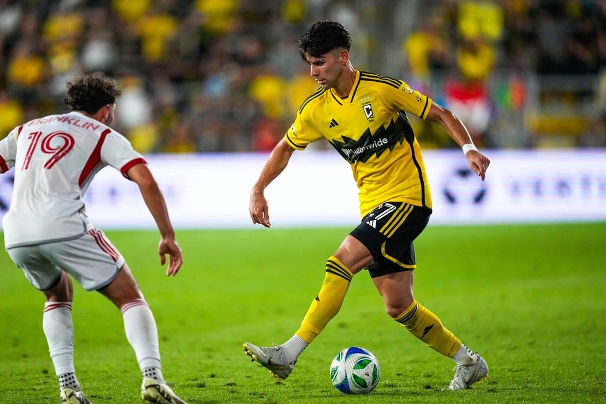 Columbus Crew forward Max Arfsten (27) moves the ball past Toronto FC defender Kobe Franklin (19) in the second half at Lower.com Field on Saturday, Sept. 20, 2025 in Columbus, Ohio.