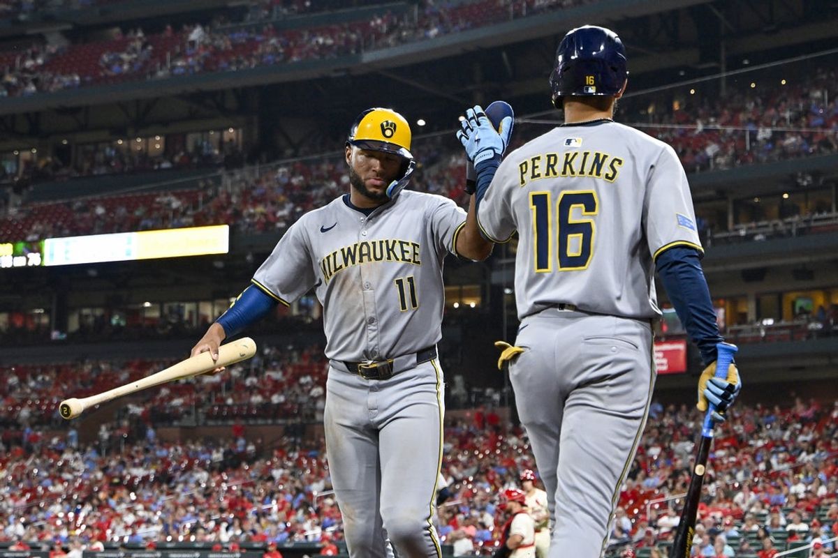Sep 20, 2025; St. Louis, Missouri, USA; Milwaukee Brewers left fielder Jackson Chourio (11) is congratulated by center fielder Blake Perkins (16) after scoring against the St. Louis Cardinals during the tenth inning at Busch Stadium. Mandatory Credit: Jeff Curry-Imagn Images