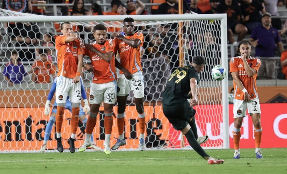 Sep 20, 2025; Houston, Texas, USA;  Portland Timbers forward Kristoffer Velde (99) kicks a free kick against the Houston Dynamo FC in the second half at Shell Energy Stadium. Mandatory Credit: Thomas Shea-Imagn Images