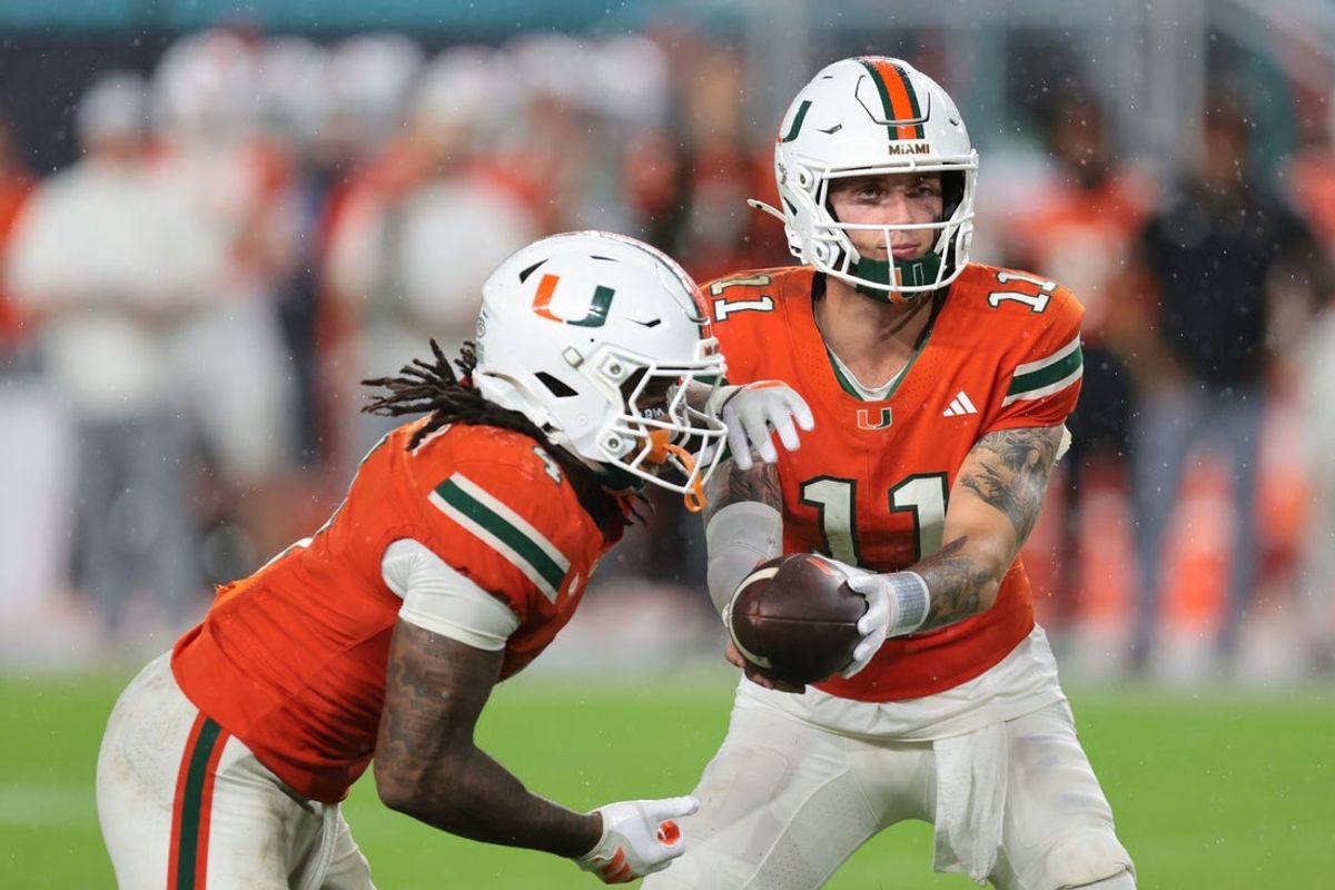 Sep 20, 2025; Miami Gardens, Florida, USA; Florida Gators wide receiver Aidan Mizell (11) handoffs the football to running back Mark Fletcher Jr. (4) against the Florida Gators during the fourth quarter at Hard Rock Stadium. Mandatory Credit: Sam Navarro-Imagn Images