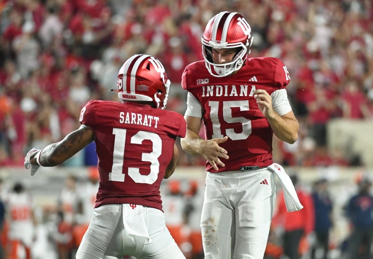 Sep 20, 2025; Bloomington, Indiana, USA; Indiana Hoosiers wide receiver Elijah Sarratt (13) and IIndiana Hoosiers quarterback Fernando Mendoza (15) celebrate after a touchdown during the second half against the Illinois Fighting Illini at Memorial Stadium. Mandatory Credit: Robert Goddin-Imagn Images