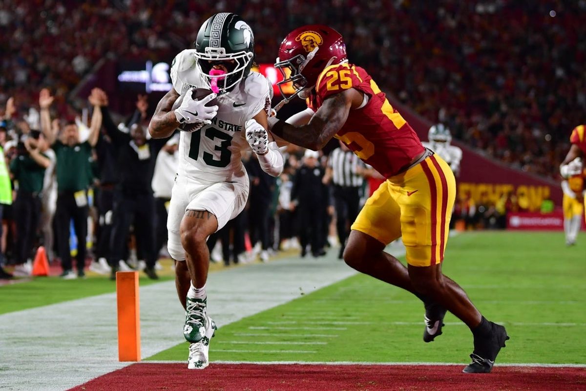 Sep 20, 2025; Los Angeles, California, USA; Michigan State Spartans wide receiver Chrishon McCray (13) score a touchdown against Southern California Trojans cornerback Marcelles Williams (25) during the first half at the Los Angeles Memorial Coliseum. Mandatory Credit: Gary A. Vasquez-Imagn Images