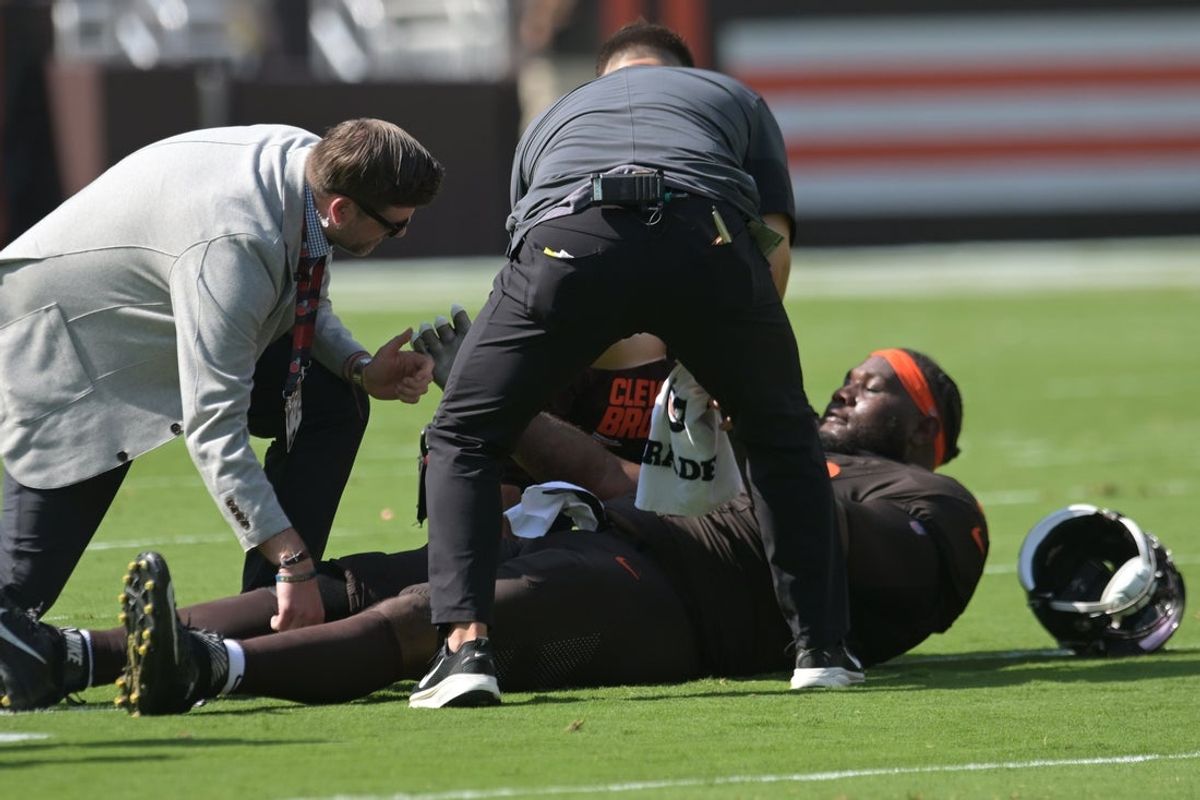 Sep 21, 2025; Cleveland, Ohio, USA; Cleveland Browns offensive tackle Dawand Jones (79) lies on the field after being injured against the Green Bay Packers during the first quarter at Huntington Bank Field. Mandatory Credit: Ken Blaze-Imagn Images