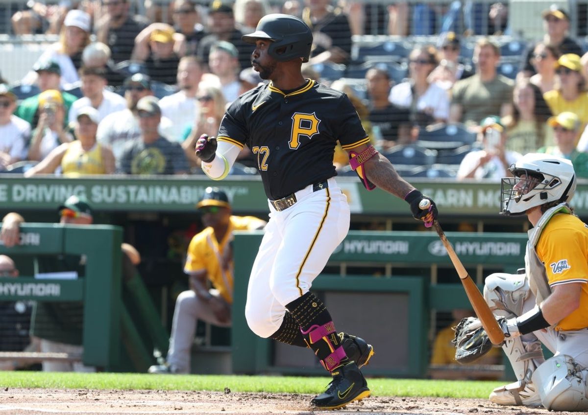 Sep 21, 2025; Pittsburgh, Pennsylvania, USA;  Pittsburgh Pirates designated hitter Andrew McCutchen (22) hits an RBI single against the Athletics during the first inning at PNC Park. Mandatory Credit: Charles LeClaire-Imagn Images