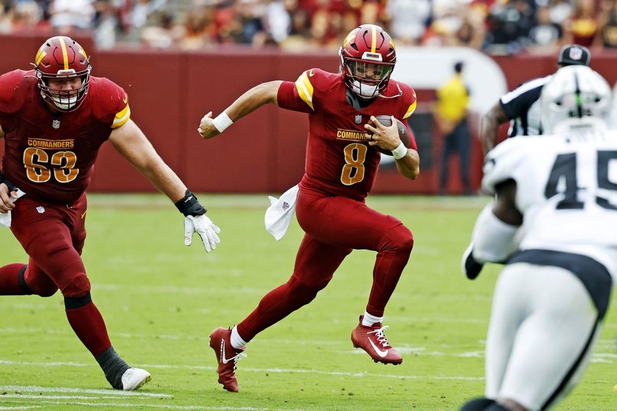 Sep 21, 2025; Landover, Maryland, USA; Washington Commanders quarterback Marcus Mariota (8) runs the ball during the first half against the Las Vegas Raiders at Northwest Stadium. Mandatory Credit: Geoff Burke-Imagn Images