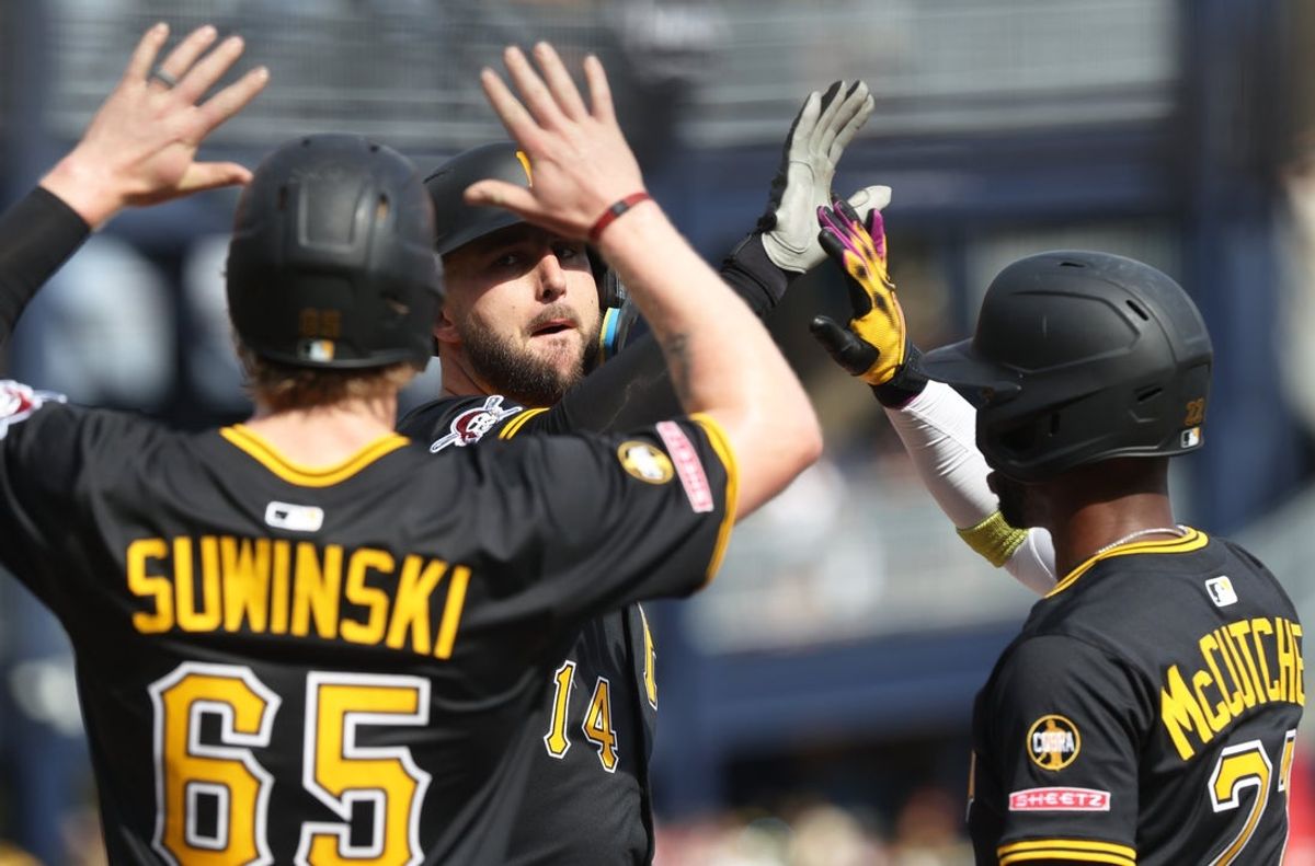 Sep 21, 2025; Pittsburgh, Pennsylvania, USA;  Pittsburgh Pirates left fielder Jack Suwinski (65) and designated hitter Andrew McCutchen (22) greet catcher Joey Bart (middle) crossing home plate on a three run hime run against the Athletics during the fifth inning at PNC Park. Mandatory Credit: Charles LeClaire-Imagn Images