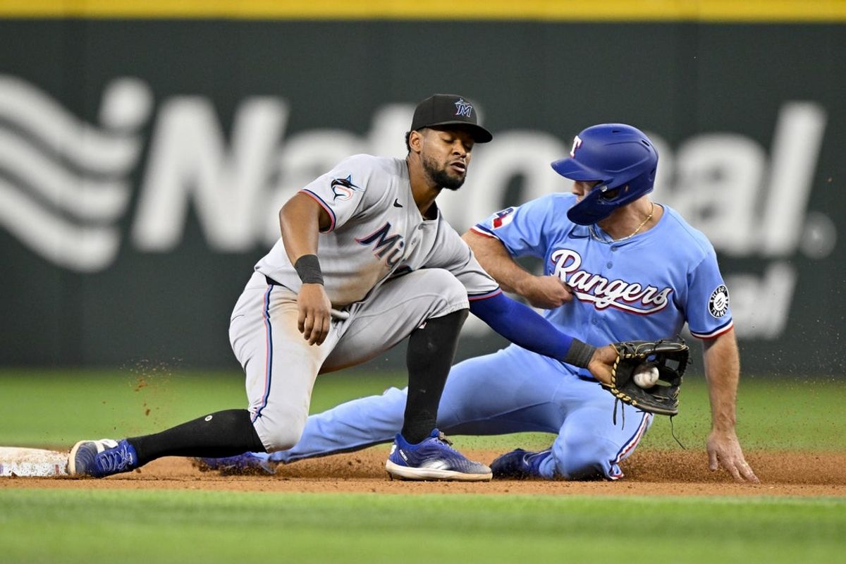 Sep 21, 2025; Arlington, Texas, USA; Texas Rangers left fielder Wyatt Langford (36) steals second base past Miami Marlins shortstop Otto Lopez (6) during the sixth inning at Globe Life Field. Mandatory Credit: Jerome Miron-Imagn Images