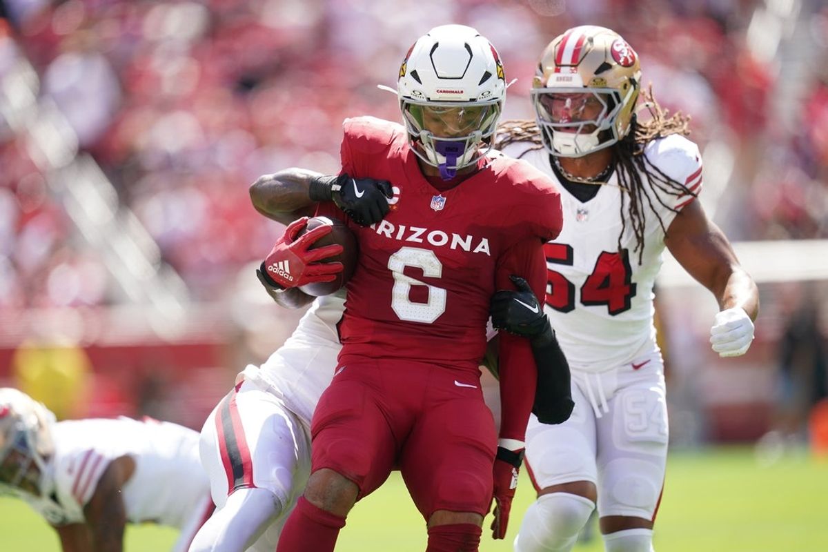 Sep 21, 2025; Santa Clara, California, USA; Arizona Cardinals running back James Conner (6) is tackled by San Francisco 49ers linebacker Dee Winters (53) during the first half at Levi's Stadium. Mandatory Credit: Cary Edmondson-Imagn Images