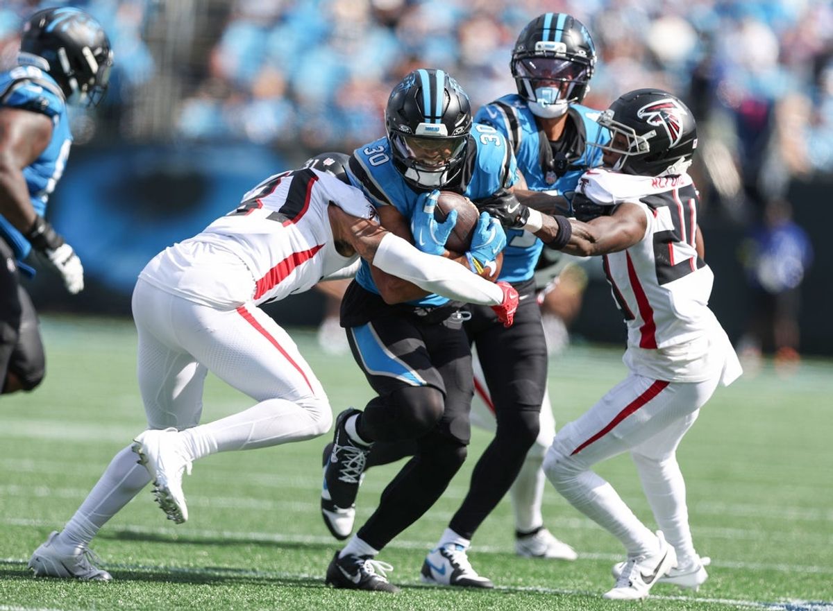 Sep 21, 2025; Charlotte, North Carolina, USA;  Carolina Panthers running back Chuba Hubbard (30) runs the ball against the Atlanta Falcons at Bank of America Stadium. Mandatory Credit: Cory Knowlton-Imagn Images