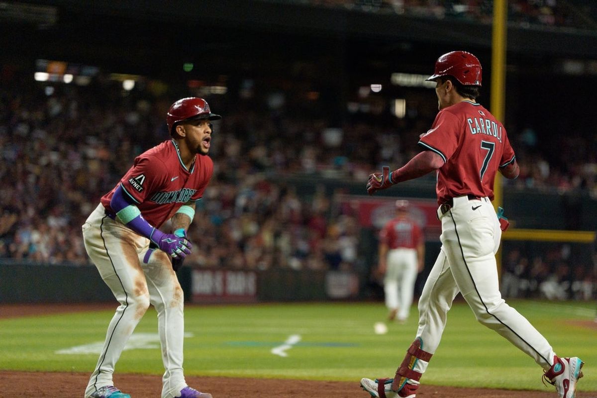 Sep 21, 2025; Phoenix, Arizona, USA; Arizona Diamondbacks outfielder Corbin Carroll (7) and infielder Ketel Marte celebrates after Carrol hit a home run in the second inning against the Philadelphia Phillies at Chase Field. Mandatory Credit: Allan Henry-Imagn Images