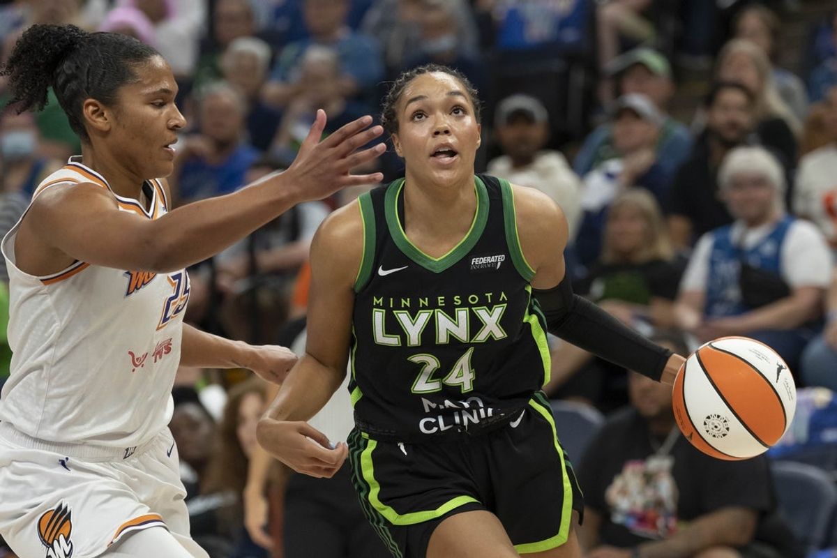 Sep 21, 2025; Minneapolis, Minnesota, USA; Minnesota Lynx forward Napheesa Collier (24) dribbles the ball past Phoenix Mercury forward Alyssa Thomas (25) in the first half during game one of the second round for the 2025 WNBA Playoffs at Target Center. Mandatory Credit: Jesse Johnson-Imagn Images