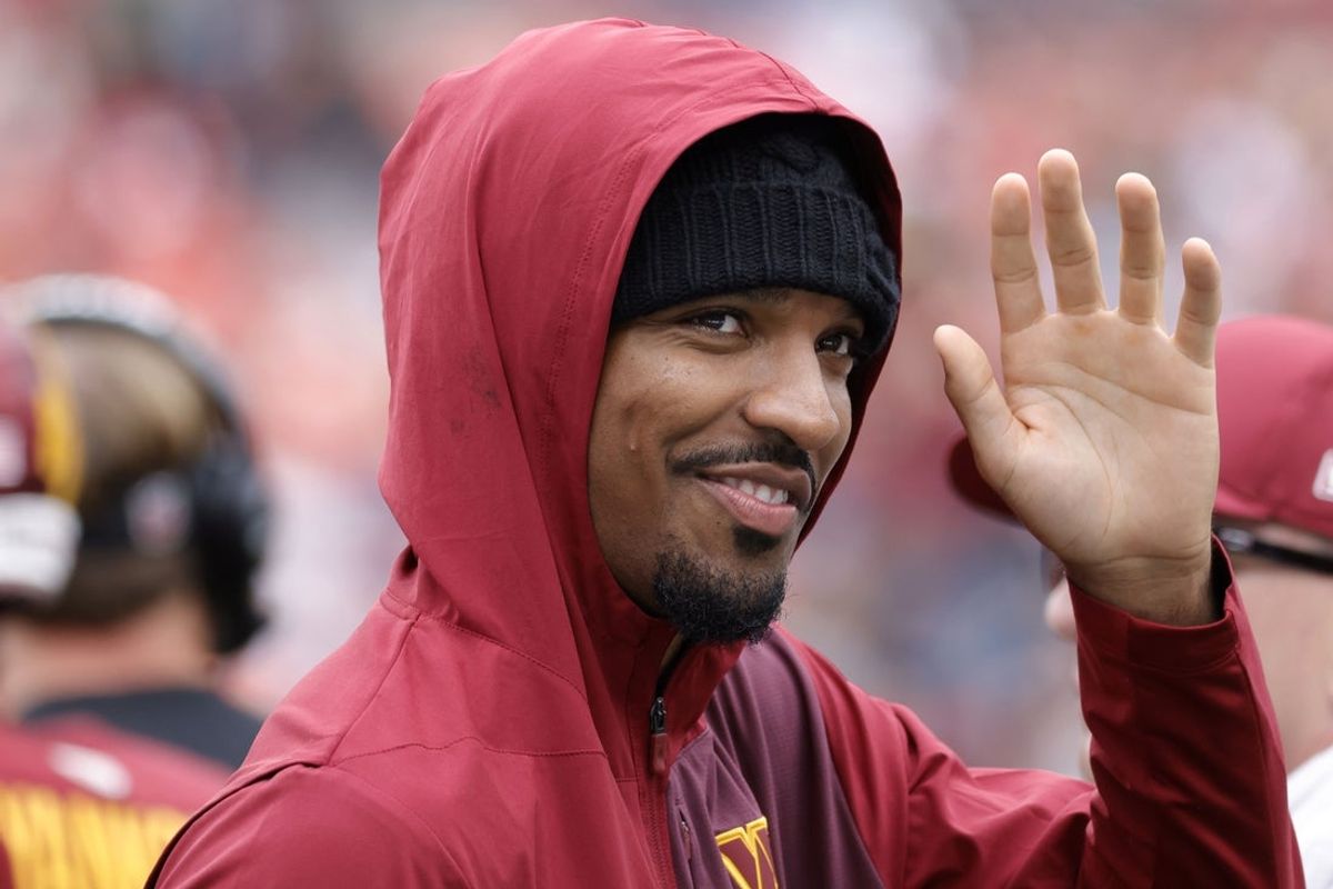 Sep 21, 2025; Landover, Maryland, USA; Injured Washington Commanders quarterback Jayden Daniels  waves to fans while walking off the field after the Commanders' game against the Las Vegas Raiders at Northwest Stadium. Mandatory Credit: Amber Searls-Imagn Images