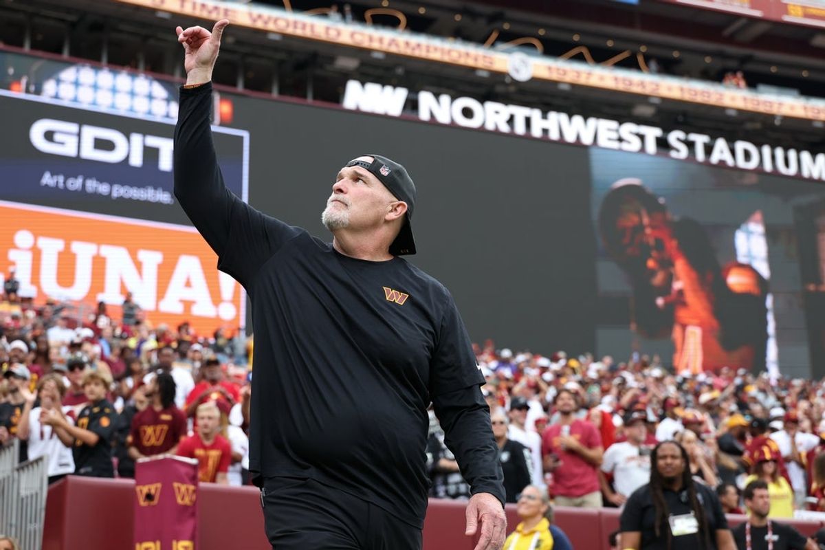 Sep 21, 2025; Landover, Maryland, USA; Washington Commanders head coach Dan Quinn waves while walking onto the field prior to the Commanders' game against the Las Vegas Raiders at Northwest Stadium. Mandatory Credit: Geoff Burke-Imagn Images