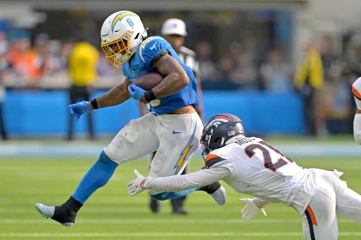 Sep 21, 2025; Inglewood, California, USA;  Los Angeles Chargers running back Omarion Hampton (8) is tripped up by Denver Broncos cornerback Riley Moss (21) after a first down in the fourth quarter at SoFi Stadium. Mandatory Credit: Jayne Kamin-Oncea-Imagn Images