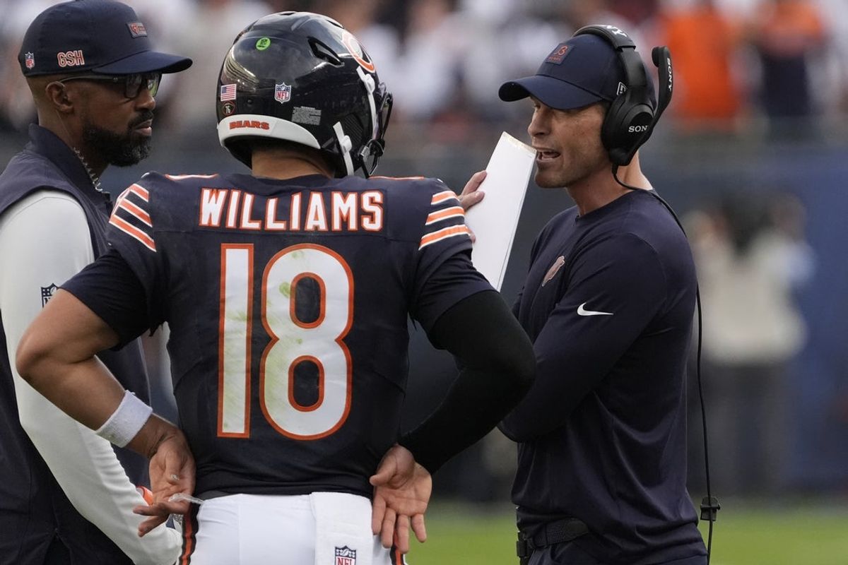 Sep 21, 2025; Chicago, Illinois, USA; Chicago Bears head coach Ben Johnson talks with quarterback Caleb Williams (18) against the Dallas Cowboys during the second half at Soldier Field. Mandatory Credit: David Banks-Imagn Images