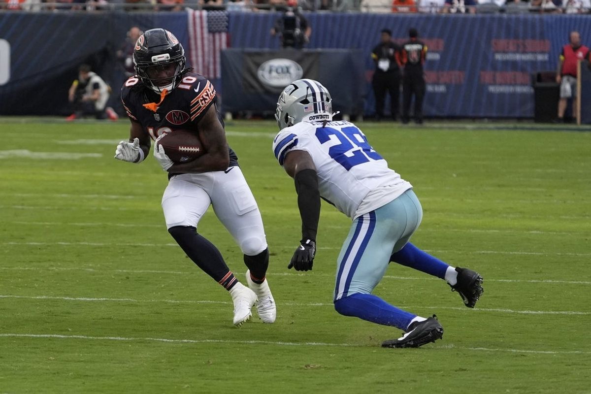Sep 21, 2025; Chicago, Illinois, USA; Dallas Cowboys free safety Malik Hooker (28) tackles Chicago Bears wide receiver Luther Burden III (10) during the second half at Soldier Field. Mandatory Credit: David Banks-Imagn Images