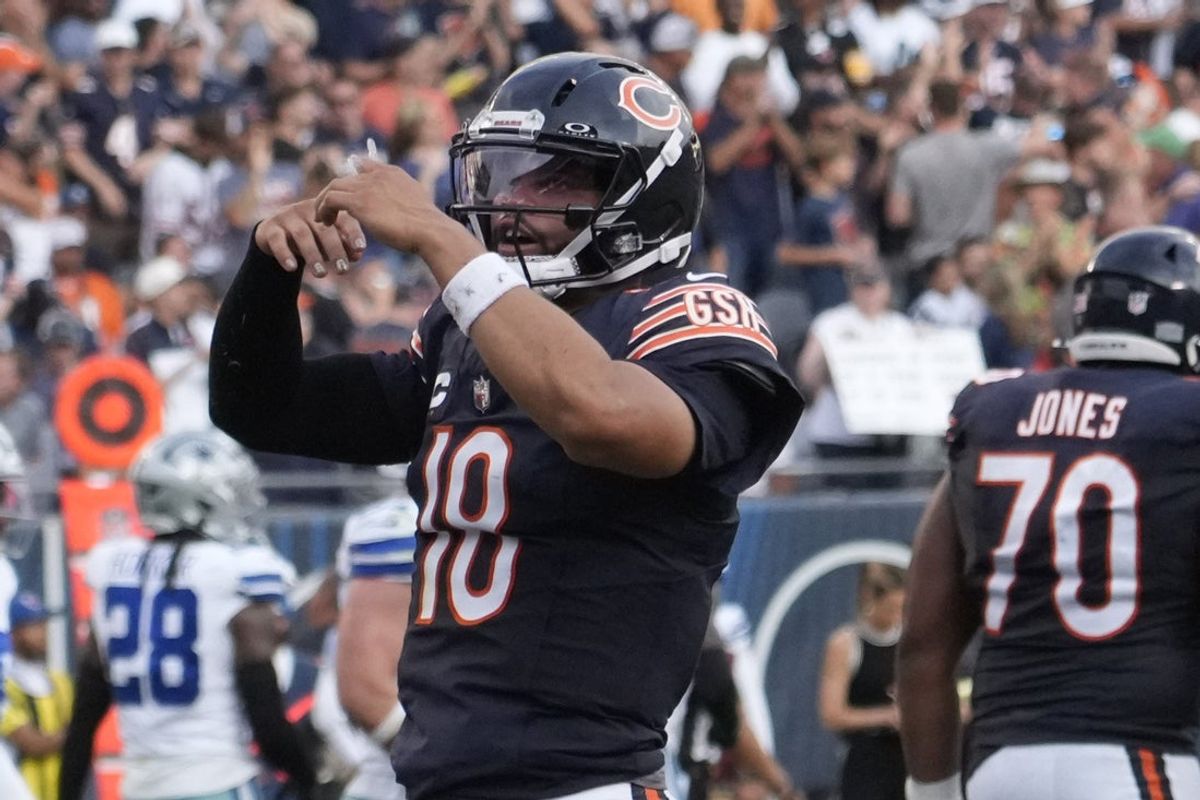 Sep 21, 2025; Chicago, Illinois, USA; Chicago Bears quarterback Caleb Williams (18) gestures after throwing a touchdown  against the Dallas Cowboys during the second half at Soldier Field. Mandatory Credit: David Banks-Imagn Images