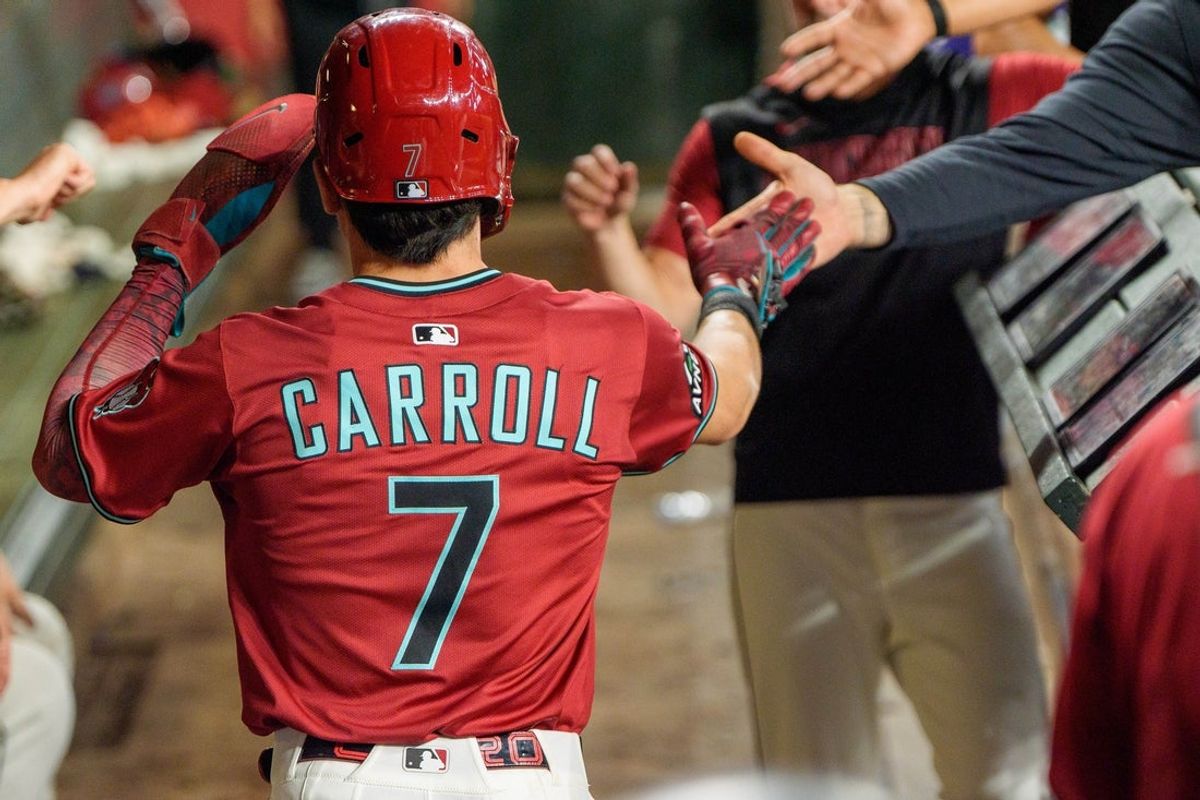 Sep 21, 2025; Phoenix, Arizona, USA; Arizona Diamondbacks outfielder Corbin Carroll (7) celebreats with his team after scoring in the eighth inning against the Philadelphia Phillies at Chase Field. Mandatory Credit: Allan Henry-Imagn Images