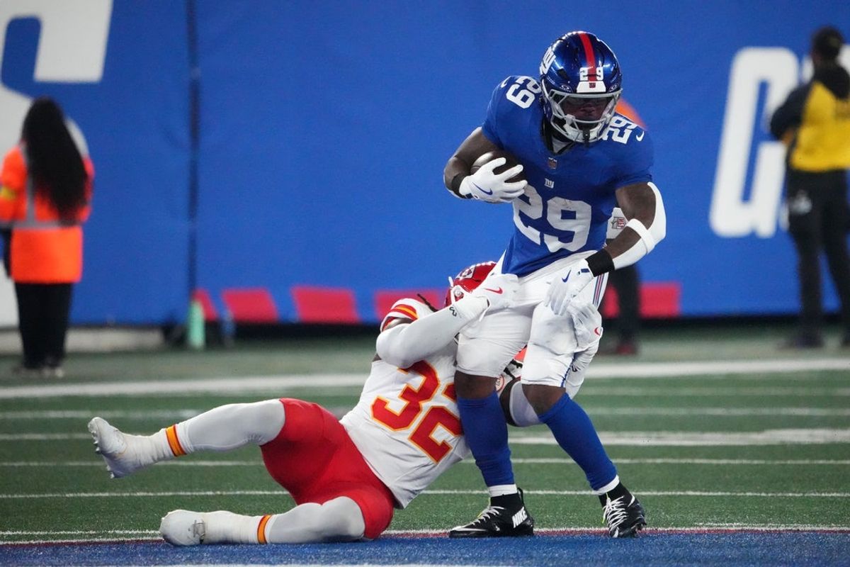 Sep 21, 2025; East Rutherford, New Jersey, USA; Kansas City Chiefs linebacker Nick Bolton (32) tackles New York Giants running back Tyrone Tracy Jr. (29) in the first quarter at MetLife Stadium. Mandatory Credit: Robert Deutsch-Imagn Images