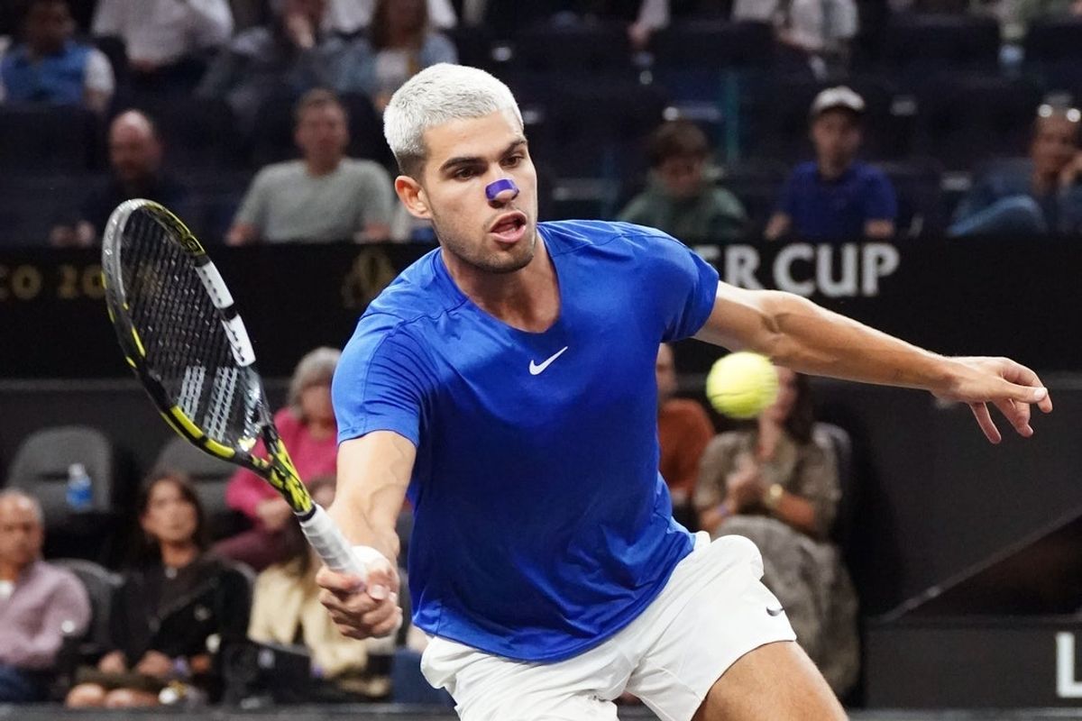Sep 21, 2025; San Francisco, CA, USA;  Team Europe player Carlos Alcaraz returns a shot from Team World player Francisco Cerundolo during the Laver Cup at Chase Center. Mandatory Credit: David Gonzales-Imagn Images