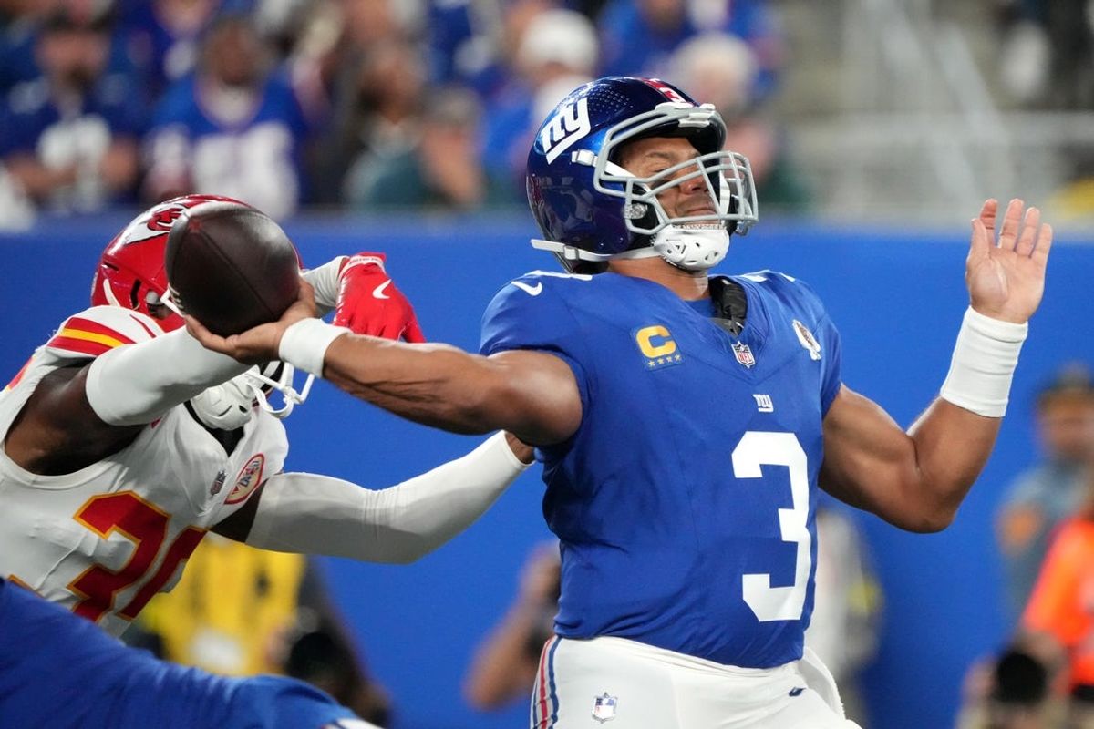 Sep 21, 2025; East Rutherford, New Jersey, USA; New York Giants quarterback Russell Wilson (3) throws under pressure from Kansas City Chiefs cornerback Jaylen Watson (35) in the second quarter at MetLife Stadium. Mandatory Credit: Robert Deutsch-Imagn Images