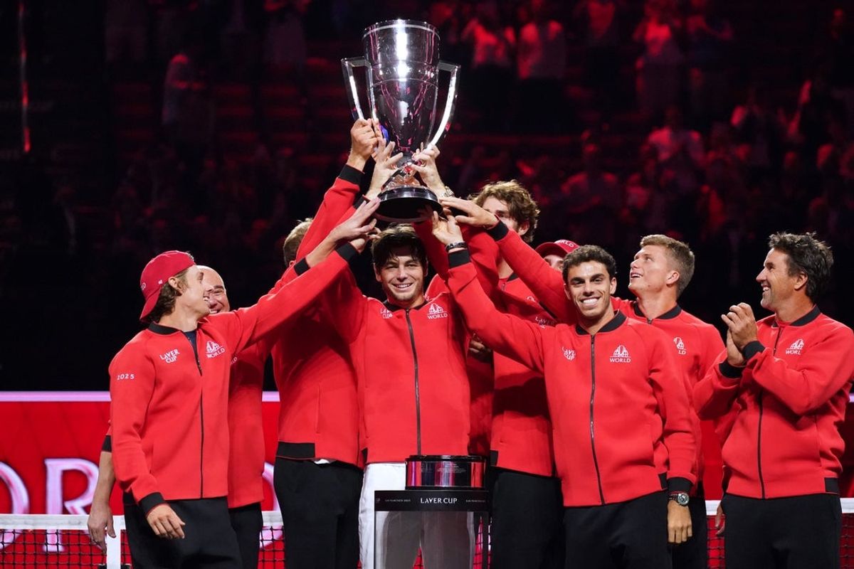 Sep 21, 2025; San Francisco, CA, USA;  Team World player Taylor Fritz hoists the trophy with teammates after defeating Team Europe during the Laver Cup at Chase Center. Mandatory Credit: David Gonzales-Imagn Images