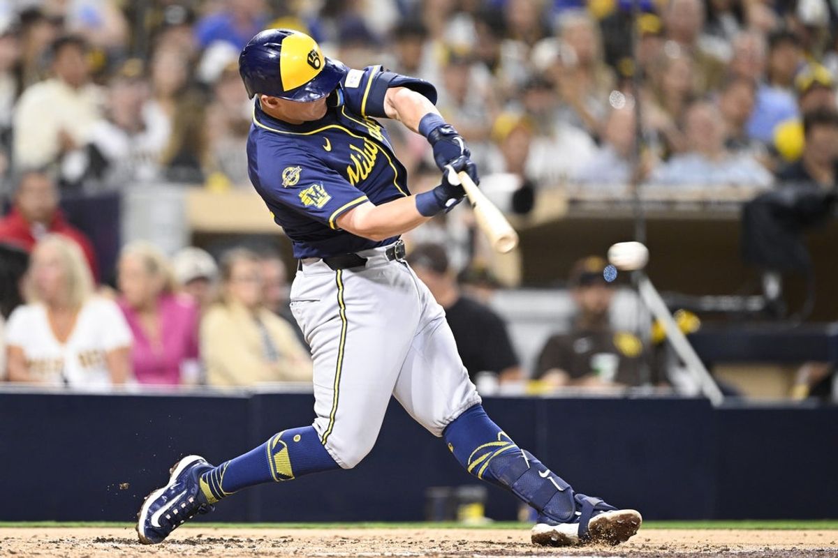 Sep 22, 2025; San Diego, California, USA; Milwaukee Brewers first baseman Andrew Vaughn (28) hits a single during the fourth inning against the San Diego Padres at Petco Park. Mandatory Credit: Denis Poroy-Imagn Images