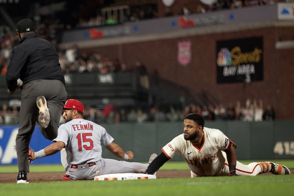 Sep 22, 2025; San Francisco, California, USA; St. Louis Cardinals second baseman José Fermín (15) tags out San Francisco Giants left fielder Heliot Ramos (17) after he overran first base on a two-RBI single during the fourth inning at Oracle Park. Umpire is Malachi Moore. Mandatory Credit: D. Ross Cameron-Imagn Images