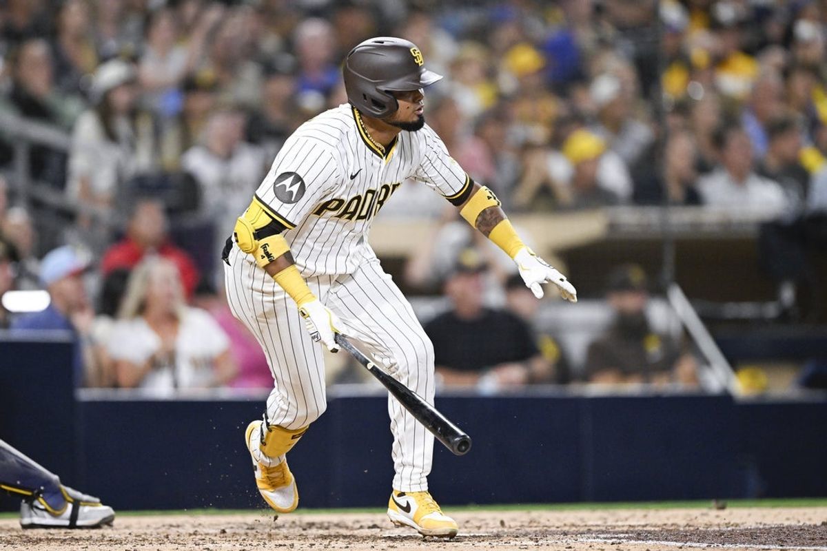 Sep 22, 2025; San Diego, California, USA; San Diego Padres first baseman Luis Arraez (4) hits an RBI single during the seventh inning against the Milwaukee Brewers at Petco Park. Mandatory Credit: Denis Poroy-Imagn Images