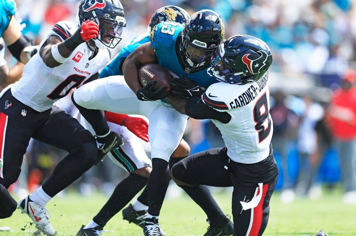 Jacksonville Jaguars running back Bhayshul Tuten (33) is tackled by Houston Texans safety CJ. Gardner-Johnson (8) during the second quarter of an NFL football matchup at EverBank Stadium, Sunday, Sept. 21, 2025, in Jacksonville, Fla. The Jaguars defeated the Texans 17-10. The Jaguars defeated the Texans 17-10.