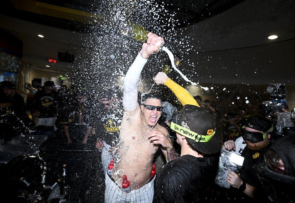 Sep 22, 2025; San Diego, California, USA; San Diego Padres third baseman Manny Machado (13) celebrates after the Padres clinched a spot in the National League Wild Card Series by beating the Milwaukee Brewers at Petco Park. Mandatory Credit: Denis Poroy-Imagn Images