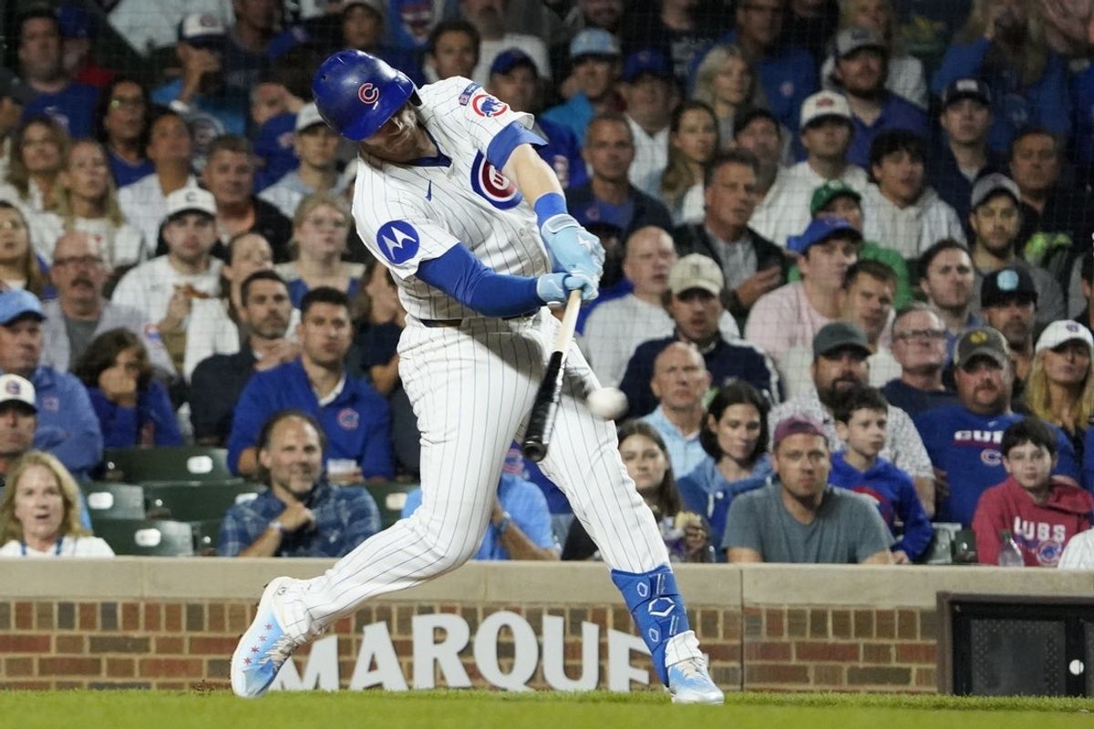 Sep 23, 2025; Chicago, Illinois, USA; Chicago Cubs outfielder Ian Happ (8) hits a two-run double against the New York Mets during the second inning at Wrigley Field. Mandatory Credit: David Banks-Imagn Images