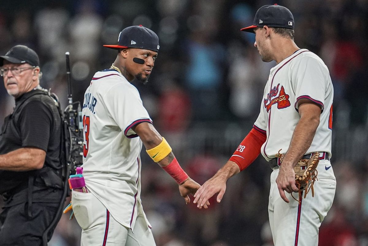 Sep 23, 2025; Cumberland, Georgia, USA; Atlanta Braves right fielder Ronald Acuna Jr (13) and first baseman Matt Olson (28) react after the Braves defeated the Washington Nationals at Truist Park. Mandatory Credit: Dale Zanine-Imagn Images