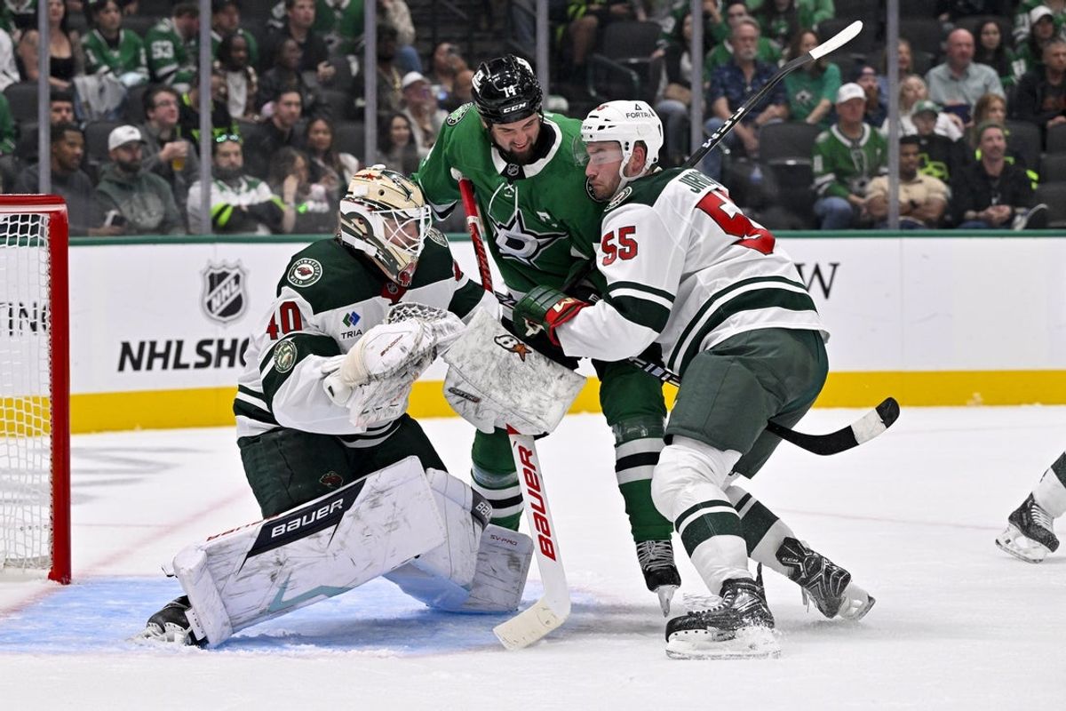 Sep 23, 2025; Dallas, Texas, USA; Dallas Stars left wing Jamie Benn (14) battles for position in between Minnesota Wild goaltender Cal Petersen (40) and defenseman David Jiricek (55) during the second period at American Airlines Center. Mandatory Credit: Jerome Miron-Imagn Images