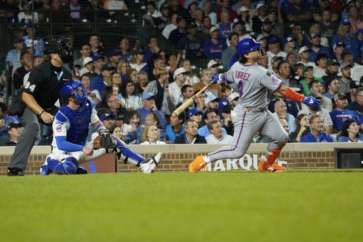 Sep 23, 2025; Chicago, Illinois, USA; New York Mets catcher Francisco Alvarez (4) hits a two-run home run against the Chicago Cubs during the eighth inning at Wrigley Field. Mandatory Credit: David Banks-Imagn Images
