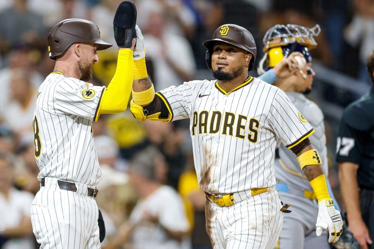 Sep 23, 2025; San Diego, California, USA; San Diego Padres designated hitter Luis Arraez (4) celebrates with second baseman Mason McCoy (18) after hitting a two-run home run during the second inning against the Milwaukee Brewers at Petco Park. Mandatory Credit: David Frerker-Imagn Images