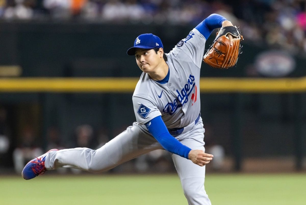 Sep 23, 2025; Phoenix, Arizona, USA; Los Angeles Dodgers pitcher Shohei Ohtani pitches in the first inning against the Arizona Diamondbacks at Chase Field. Mandatory Credit: Mark J. Rebilas-Imagn Images