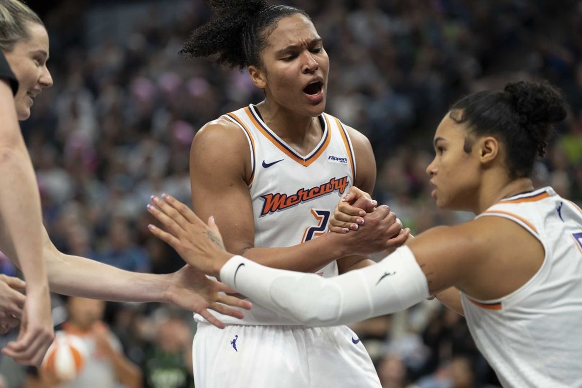 Sep 23, 2025; Minneapolis, Minnesota, USA; Phoenix Mercury forward Alyssa Thomas (25) celebrates with forward Satou Sabally (0) against the Minnesota Lynx in the second half during game two of the second round for the 2025 WNBA Playoffs at Target Center. Mandatory Credit: Jesse Johnson-Imagn Images