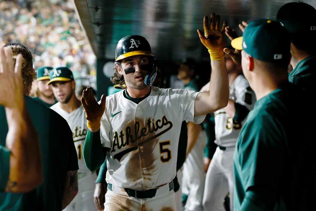Sep 23, 2025; West Sacramento, California, USA; Athletics shortstop Jacob Wilson (5) celebrates in the dugout after scoring a run during the fourth inning against the Houston Astros at Sutter Health Park. Mandatory Credit: Sergio Estrada-Imagn Images