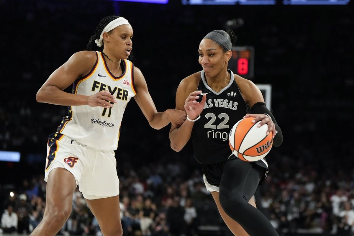 Sep 23, 2025; Las Vegas, Nevada, USA; Las Vegas Aces center A'ja Wilson (22) drives against Indiana Fever forward Brianna Turner (11) during the fourth quarter in game two of the second round for the 2025 WNBA Playoffs at Michelob Ultra Arena. Mandatory Credit: Lucas Peltier-Imagn Images