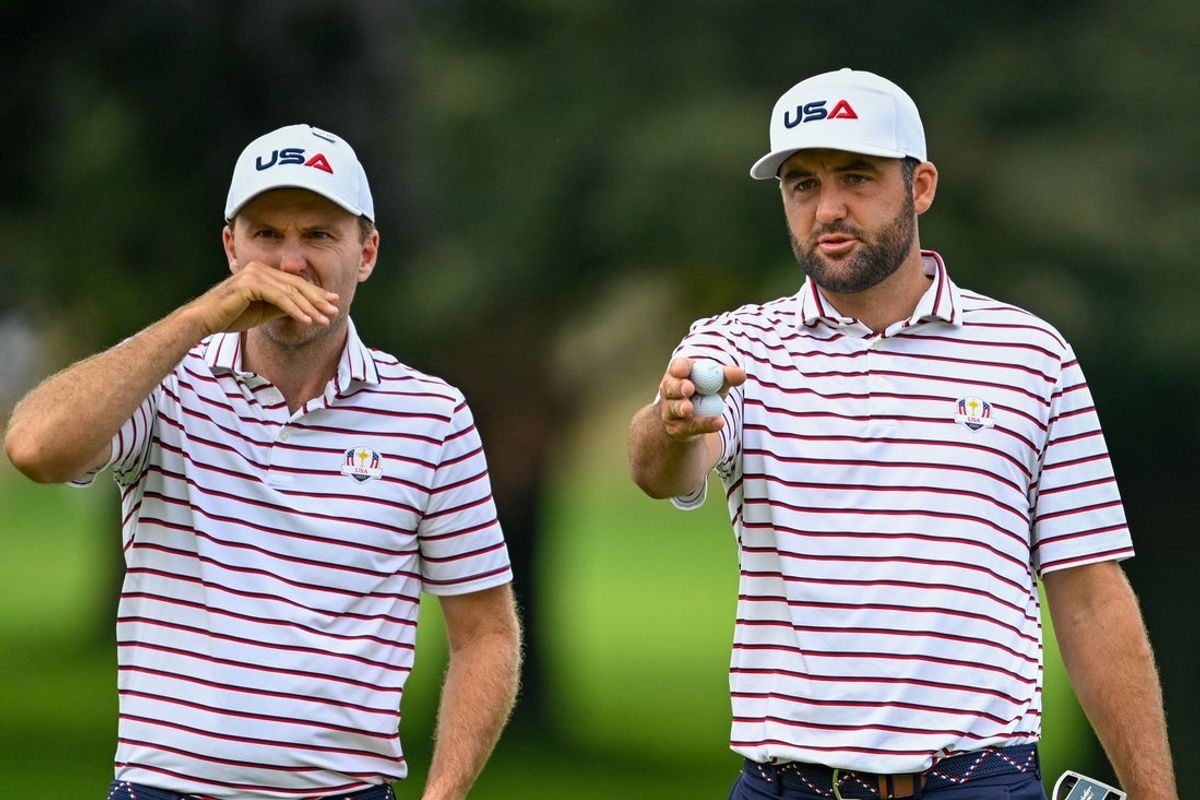 Sep 24, 2025; Bethpage, New York, USA; Scottie Scheffler and Russell Henley talk about the greens on the first hole during a practice round of the Ryder Cup golf tournament at Bethpage Black. Mandatory Credit: Dennis Schneidler-Imagn Images